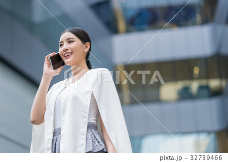 a photo of a woman talking on the phone happily 32739466
