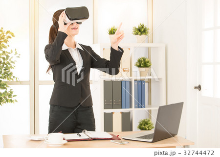 mixed race asian chinese worker excited using a VR 32744472