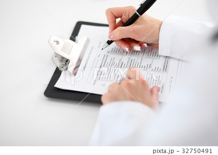 Close-up of a female doctor filling ou Close-up of a female doctor filling ou 32750491