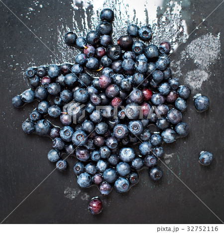 Freshly washed organic blueberries on grey slate Freshly washed organic blueberries on grey slate 32752116