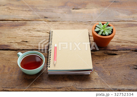 Red tea and notebook with plant Red tea and notebook with plant 32752334