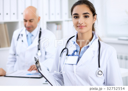 Happy doctor woman with medical staff at th Happy doctor woman with medical staff at th 32752554