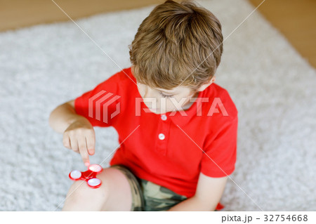 School kid playing with Tri Fidget Hand Spinner 32754668