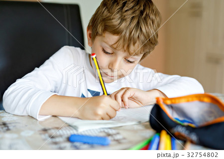 Tired kid boy at home making homework writing 32754802