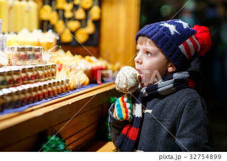 Little kid boy eating sugar apple sweets stand on Little kid boy eating sugar apple sweets stand on 32754899