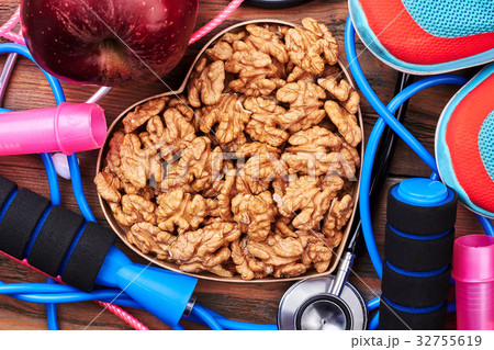Walnut, stethoscope, sneakers and apple. 32755619