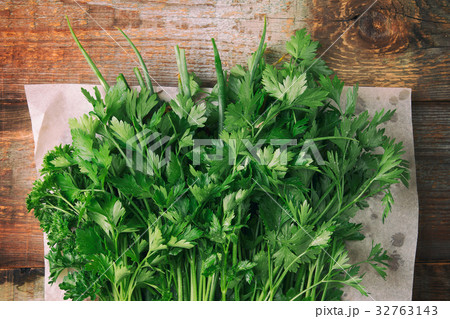 Parsley and onion on a wooden background Parsley and onion on a wooden background 32763143
