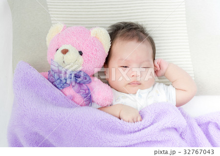 Portrait of adorable baby girl sleeping on the bed Portrait of adorable baby girl sleeping on the bed 32767043