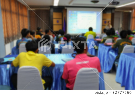 Blur Student sitting in classroom with teacher  32777560