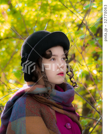 Portrait girl in bright crimson coat in autumn day 32778063