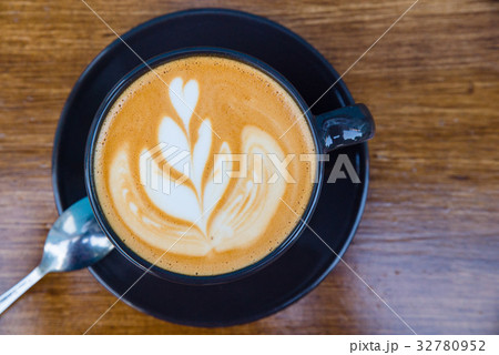 Cappuccino in a cup on the table 32780952