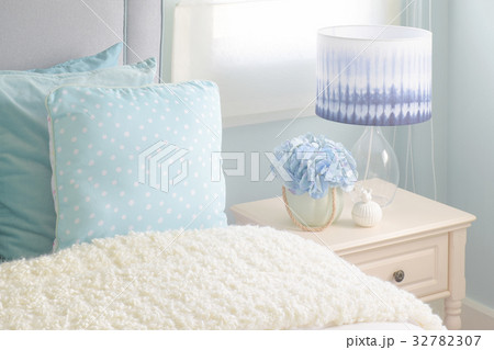 Light blue pillows and puffy blanket in bedroom Light blue pillows and puffy blanket in bedroom 32782307