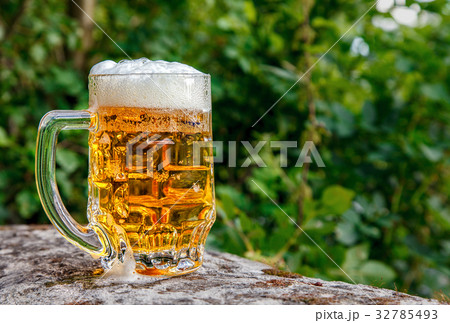 glass mug with beer standing on the big stone glass mug with beer standing on the big stone 32785493