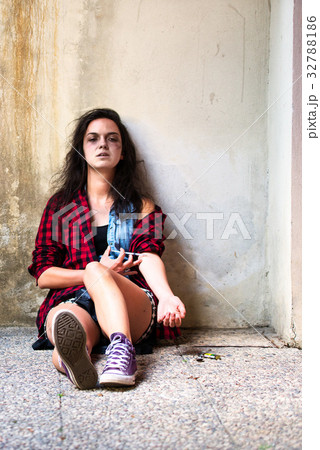 Drug-addicted girl who is crying with heroin syringe Drug-addicted girl who is crying with heroin syringe 32788186
