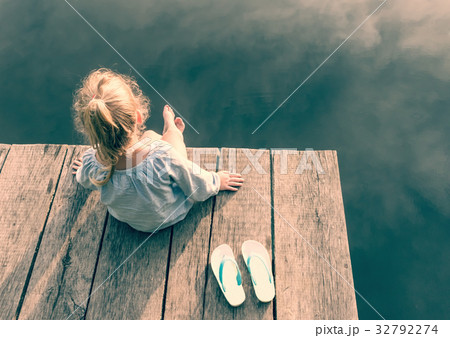 One small girl on wooden bridge One small girl on wooden bridge 32792274