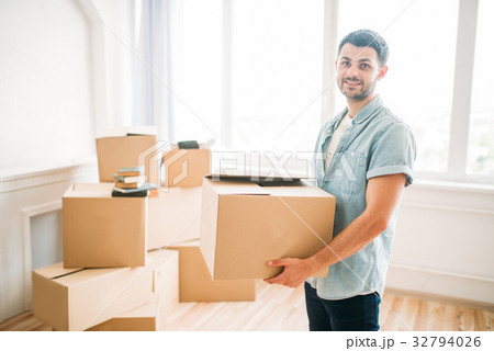 Man holds carton box in hands, housewarming Man holds carton box in hands, housewarming 32794026