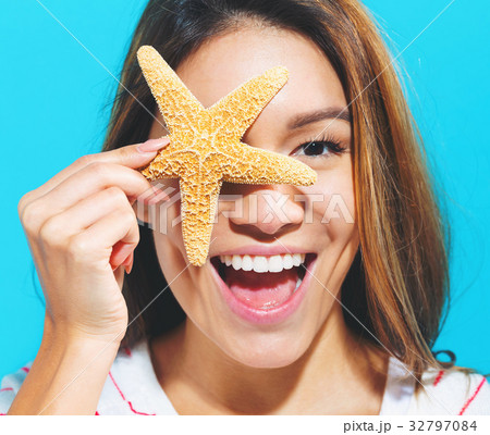Happy woman with a starfish Happy woman with a starfish 32797084