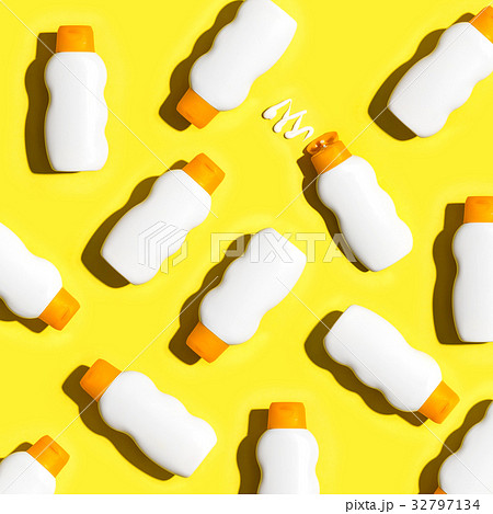 Sunblock bottles a yellow background 32797134