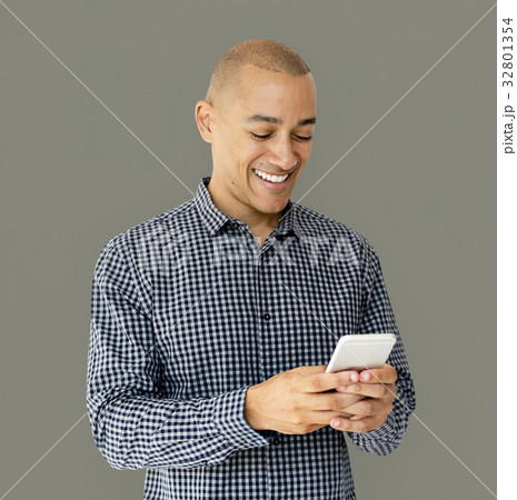 A guy is smiling using smartphone 32801354
