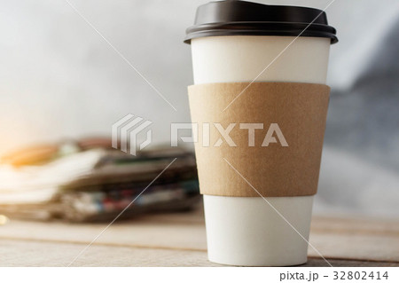 Cup of coffee on desk. 32802414