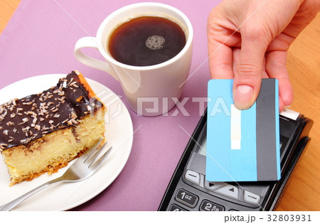 Paying with contactless credit card for cheesecake Paying with contactless credit card for cheesecake 32803931