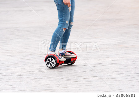 Young woman riding a hoverboard on the city square Young woman riding a hoverboard on the city square 32806881