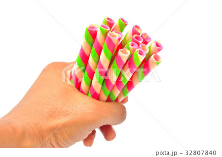 Hand grip colorful wafer roll isolated Hand grip colorful wafer roll isolated 32807840