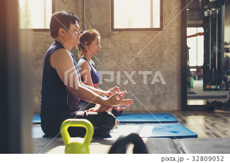 Portrait of pretty girl training in gym with her trainer helping Portrait of pretty girl training in gym with her trainer helping 32809052