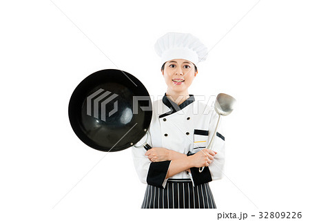 female chef showing wok and spatula tools 32809226
