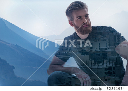 Thoughtful guy relaxing in natural environment Thoughtful guy relaxing in natural environment 32811934