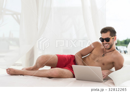 Cheerful youthful bearded guy communicating via 32812265