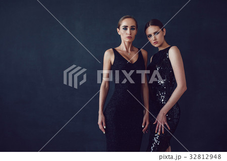 Two beautiful women in black night fashion dress Two beautiful women in black night fashion dress 32812948