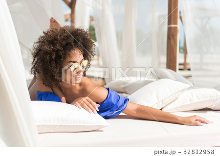 Happy youthful mulatto woman enjoying resting near 32812958