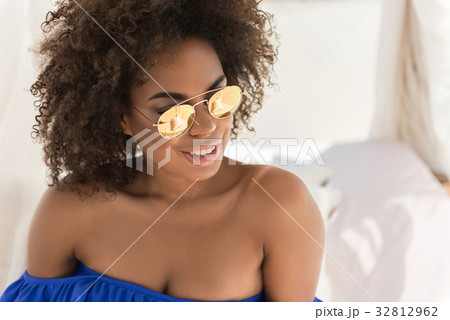 Cheery youthful mulatto woman sunbathing on Cheery youthful mulatto woman sunbathing on 32812962