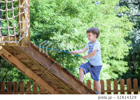 Little boy kid having fun at a wooden playground 32814329