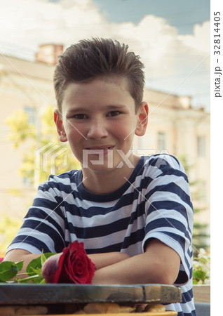 boy with rose at a table in street cafe boy with rose at a table in street cafe 32814405