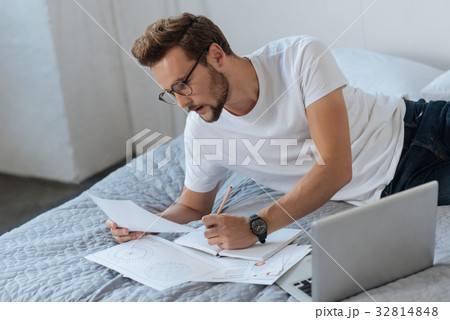 Serious brunette doing sketch of his project Serious brunette doing sketch of his project 32814848