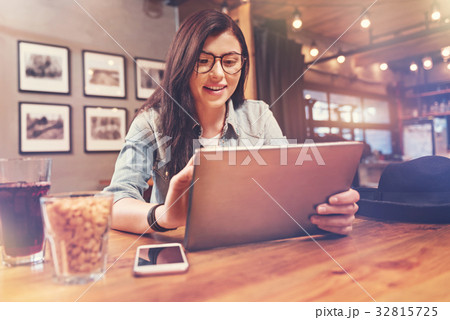 Positive delighted brunette holding her tablet 32815725