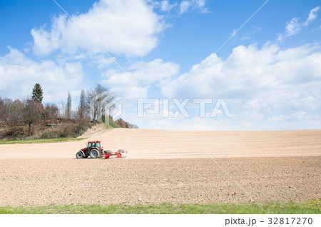Tractor compresses the soil after planting Tractor compresses the soil after planting 32817270