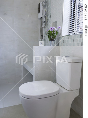 Alarm clock and flower in modern bathroom interior 32820582