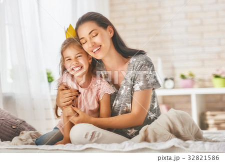 Mother and daughter playing and hugging Mother and daughter playing and hugging 32821586