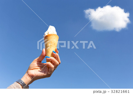 oman hand holding ice cream cone with blue sky oman hand holding ice cream cone with blue sky 32821661