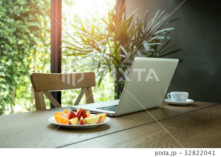 Wooden desk with fresh fruits and laptop Wooden desk with fresh fruits and laptop 32822041