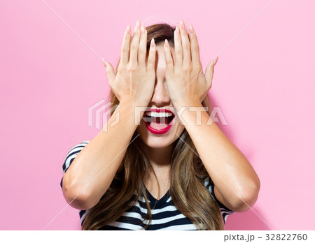 Young woman covering her eyes Young woman covering her eyes 32822760