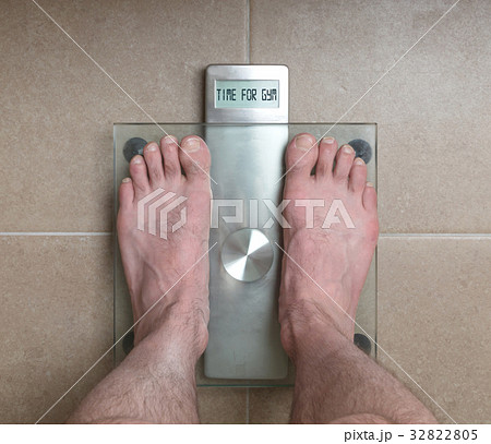 Man's feet on weight scale - Time for gym Man's feet on weight scale - Time for gym 32822805