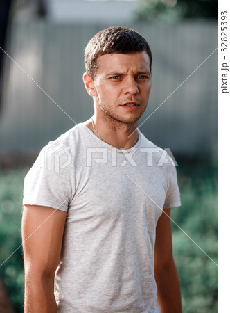 Outdoor portrait of a handsome young man in jeans 32825393