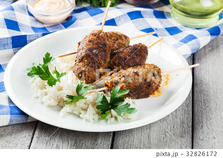 Barbecued kofta with rice on a plate 32826172