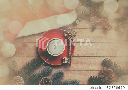 Cappuccino with key on wooden table. Cappuccino with key on wooden table. 32826699