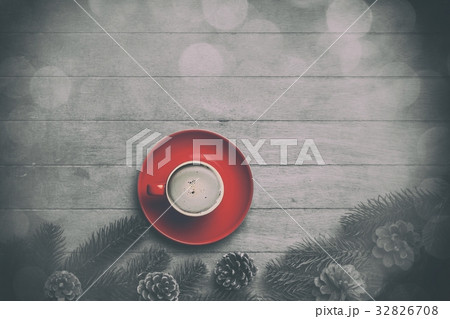 Cappuccino and  pine branch on wooden table. 32826708