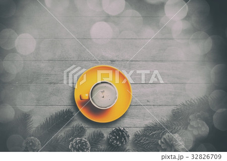 Cappuccino and  pine branch on wooden table. 32826709